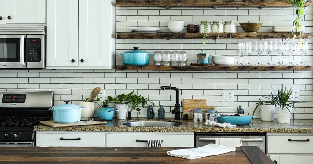 Kitchen with open shelving and white subway tile