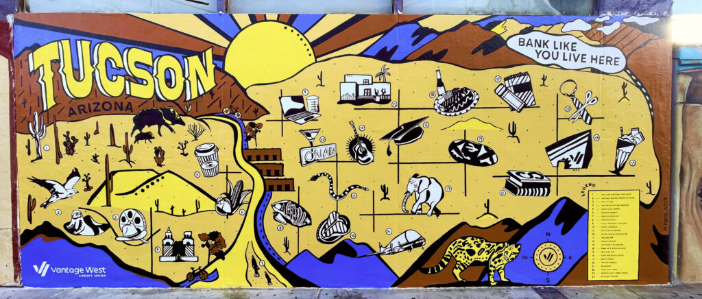 The Bank Like You Live Here mural, which includes an artistic representation of the desert in Tucson, and features black and white icons depicting favorite local attractions.