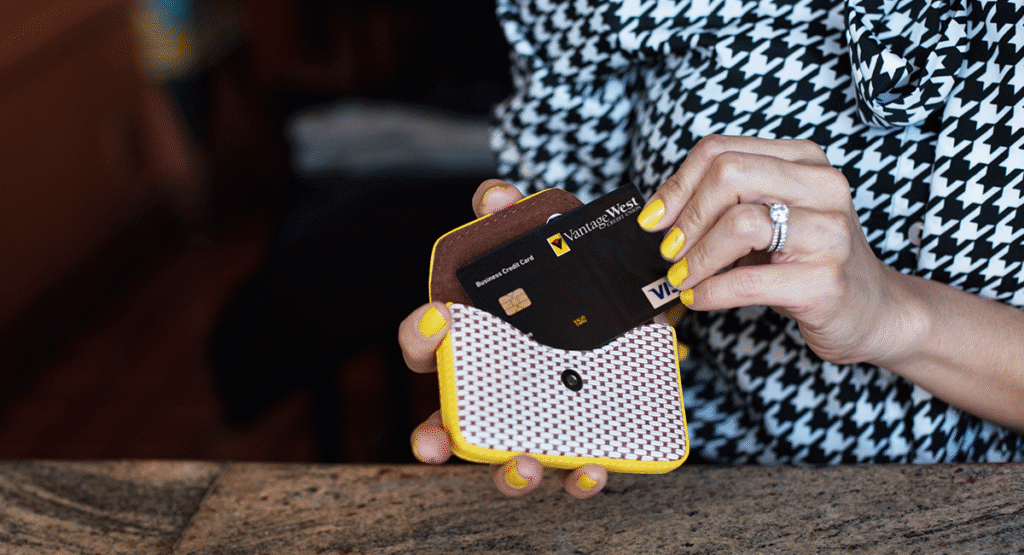 hand-with-ring-putting-VISA-credit-card-into-wallet