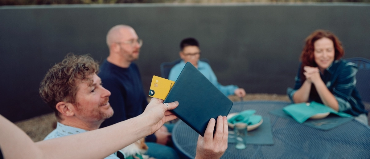 Group of diners paying for meal with Vantage West debit card