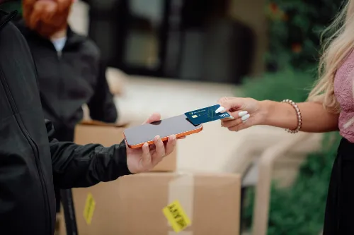 Photo of a member using their Vantage West business credit card to tap