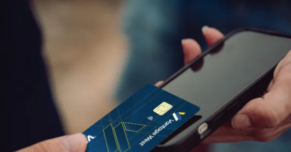 Photo of a member using a Vantage West credit card to tap
